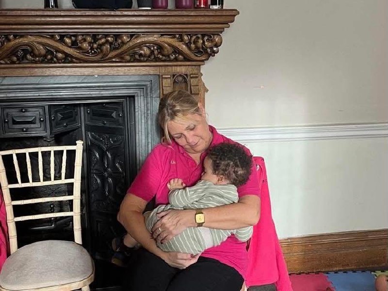 Qualified wedding nanny caring for a baby at an event